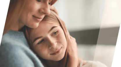 woman embracing daughter to her chest