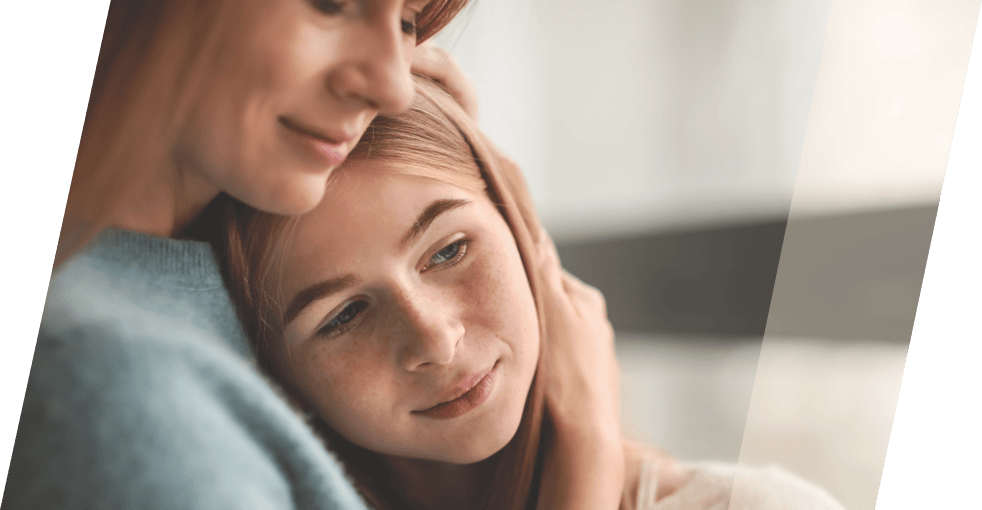 woman embracing daughter to her chest