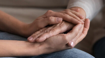 two people holding hands for care