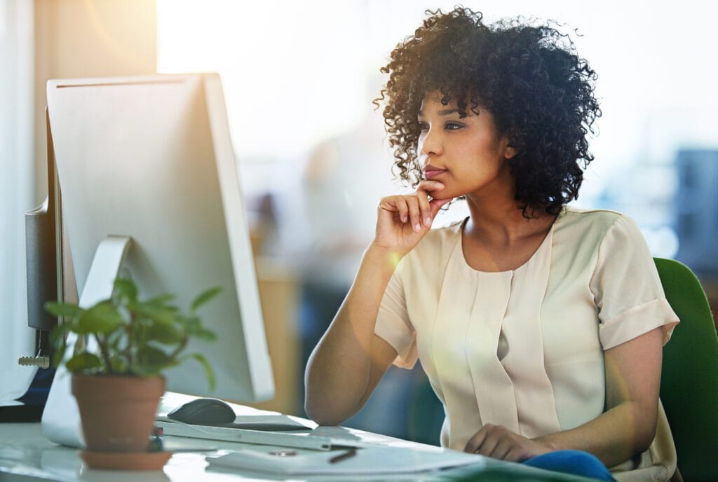 Shot of a young designer working at her computer in an office